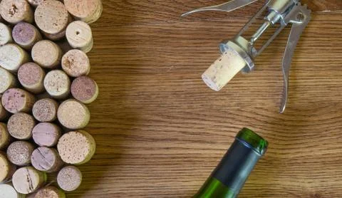 Bunch wine corks with corkscrew and bottle of wine Photos