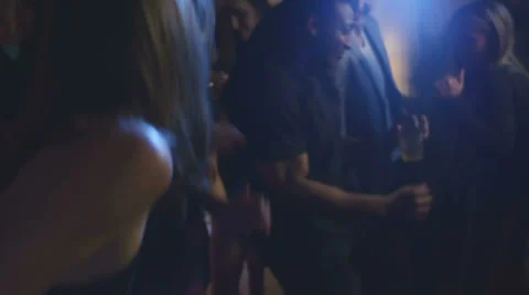 A bunch of young adults dance together at a house party Stock Footage 34015881