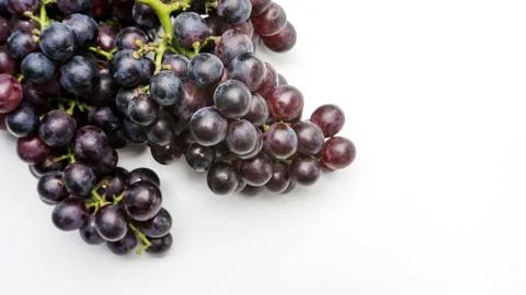 Bunches of ripe grapes on a white background. Stock Photos