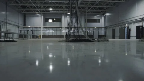Bunches of threads hang on ceiling beam in empty warehouse Stock Footage 275148382