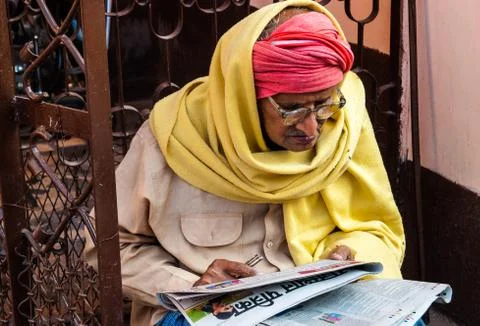 Bundi, Rajasthan, India.  Indian old man reading a newspaper on the street Stock Photos