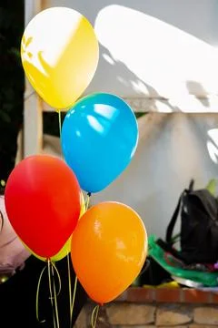 Bundle of 5 colourful helium flying balloons. Background. Birthday and Stock Photos