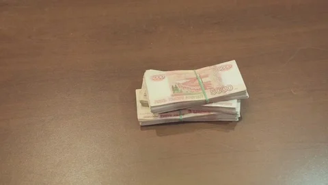 Bundle of banknotes on a table Видео 79159604