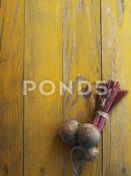 A bundle of beetroot on a yellow wooden table Stock Photos