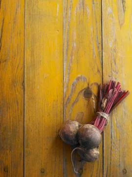A bundle of beetroot on a yellow wooden table Stock Photos