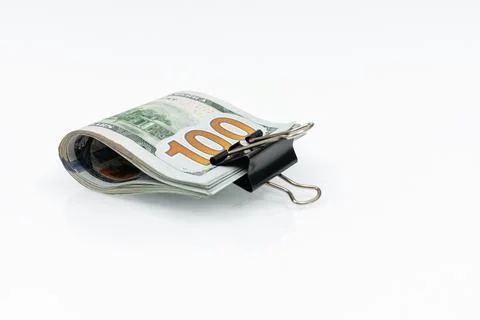 Bundle of bills of US one hundred dollars in paper clip isolated on white bac Stock Photos