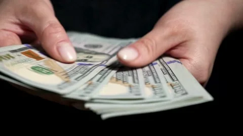 A bundle of dollar bills in female hands. Counting savings, salaries and income Stock-Footage 336260954