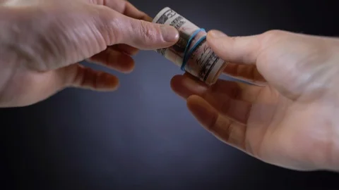 A bundle of dollar bills tied with an elastic band Видео 127541946