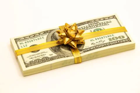 Bundle of dollars with a gift bow. Stack of dollars. US dollar banknotes Stock Photos