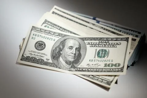 Bundle of dollars on a white table. Stock Photos