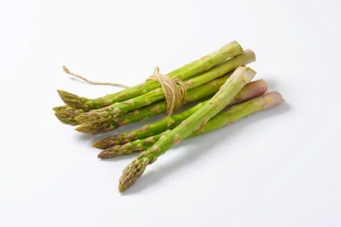 Bundle of fresh asparagus on white background Stock Photos