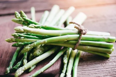 Bundle of fresh green asparagus on a rustic wooden table, asparagus bunch for Stock Photos