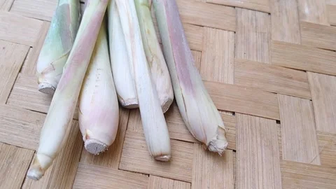 Bundle of fresh lemongrass stalks on natural woven bamboo mat Stock Footage 340538366