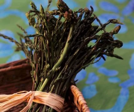 A bundle of green asparagus in a basket Stock Photos