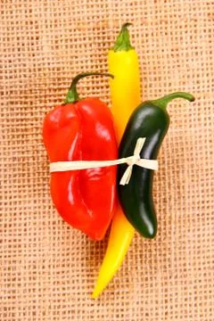 Bundle of hot pepper varieties of jute background Stock Photos