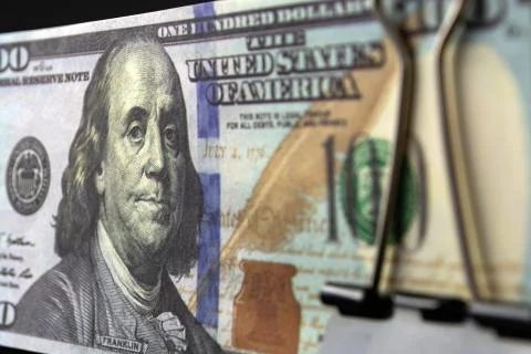 A bundle of hundred-dollar bills compressed by a binder Stock Photos