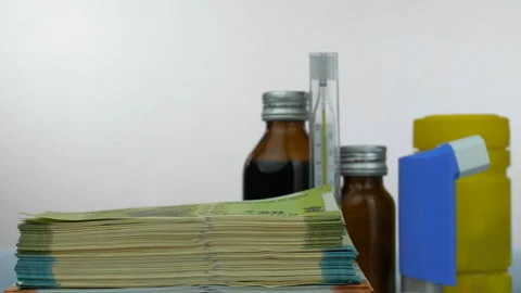 A bundle of Indian currency notes kept on the table with different medicines ... Stock-Footage 223343917