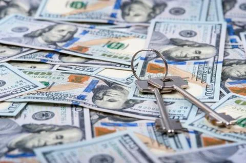 Bundle of keys on dollar bills background Stock Photos
