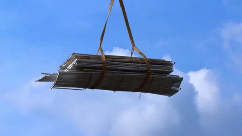 Bundle of long wooden plank wrapped with palm fiber strap hanging suspended Stockbeeldmateriaal 335253102