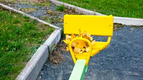 Bundle of maple leaves on sit of children teeter Stock-Fotos