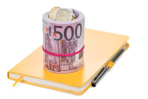 Bundle of money on a notebook Stock Photos