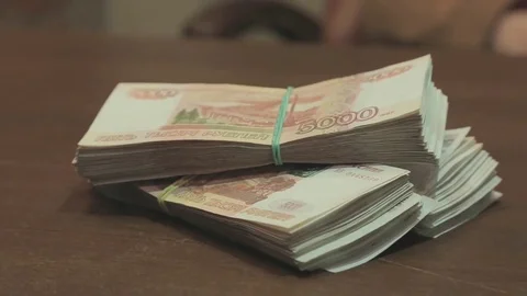 Bundle of money on a table Видео 79159462