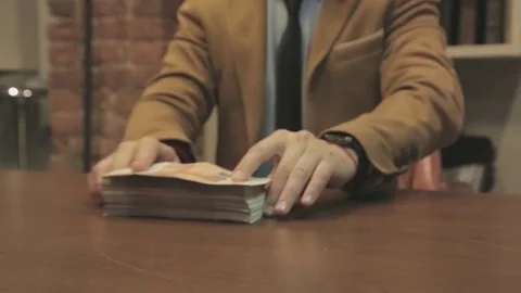Bundle of money on a table Видео 79159472