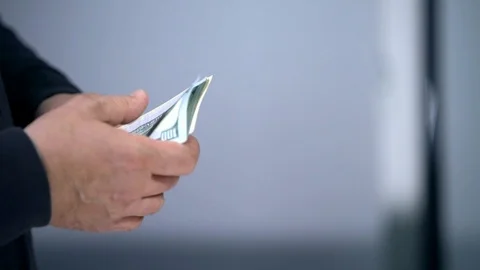 A bundle of money on the table, a lot of dollars in their hands, business people Stock Footage 100372038