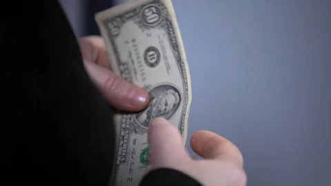 A bundle of money on the table, a lot of dollars in their hands, business people Stock Footage 100372060