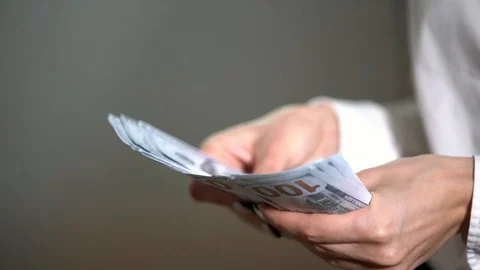 A bundle of money on the table, a lot of dollars in their hands, business people Stock Footage 100372066