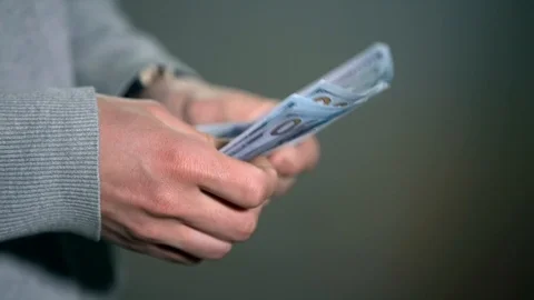 A bundle of money on the table, a lot of dollars in their hands, business people Stock Footage 100372078