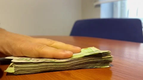 A bundle of money on the table in the office Stock Footage 252514663