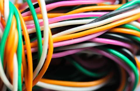 A bundle of multicolored electrical, car, computer, telephone twisted wires. Stock Photos