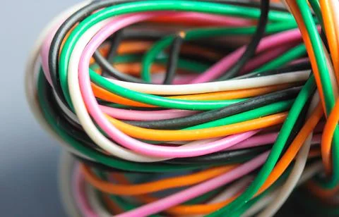 A bundle of multicolored electrical, car, computer, telephone twisted wires. Stock Photos