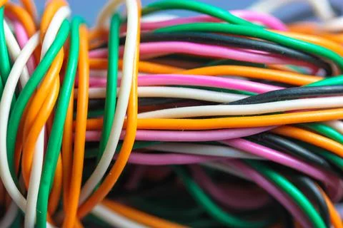A bundle of multicolored electrical, car, computer, telephone twisted wires. Stock Photos