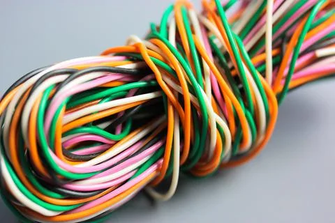A bundle of multicolored electrical, car, computer, telephone twisted wires. Stock Photos