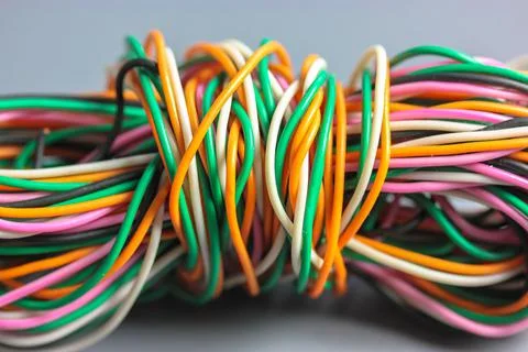 A bundle of multicolored electrical, car, computer, telephone twisted wires. Stock Photos