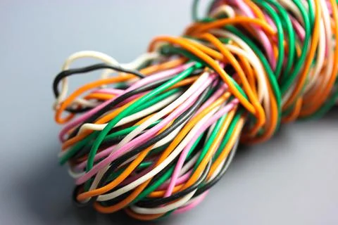 A bundle of multicolored electrical, car, computer, telephone twisted wires. Stock Photos