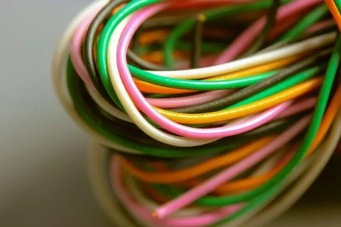 A bundle of multicolored electrical, car, computer, telephone twisted wires. Stock Photos