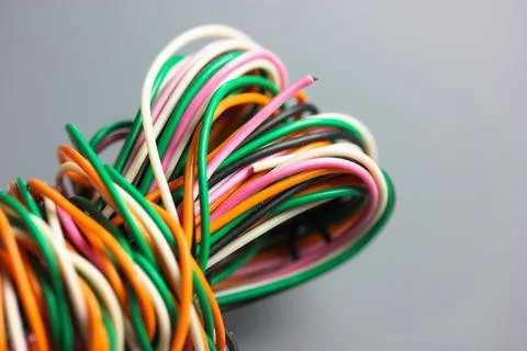 A bundle of multicolored electrical, car, computer, telephone twisted wires. Stock Photos