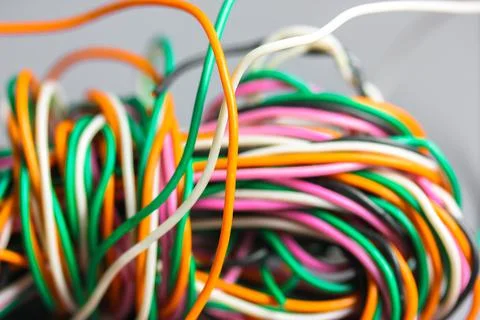 A bundle of multicolored electrical, car, computer, telephone twisted wires. Stock Photos