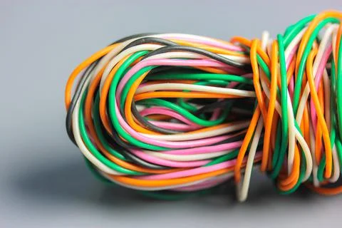 A bundle of multicolored electrical, car, computer, telephone twisted wires. Stock Photos