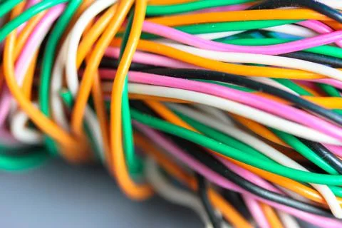 A bundle of multicolored electrical, car, computer, telephone twisted wires. Stock Photos