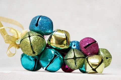Bundle of multicolored shiny jingle bell on a solid background Stock Photos