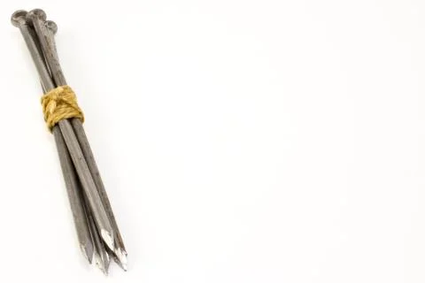 The bundle of nails tied up with rope on white background Stock Photos