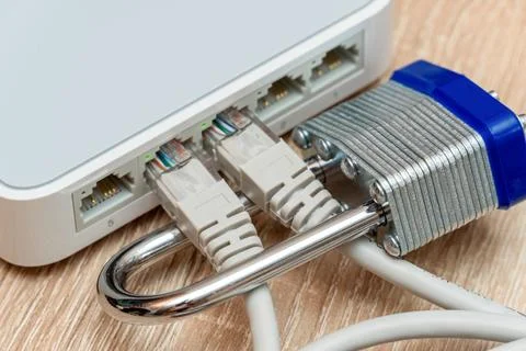 Bundle of network Ethernet wires in router locked with metal padlock Foto stock