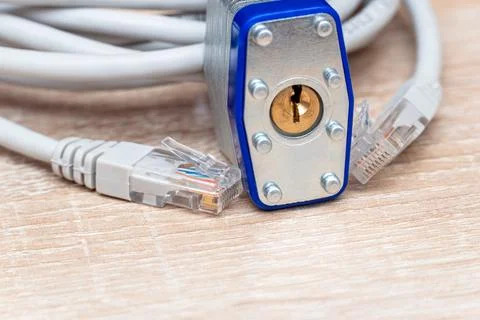 Bundle of network wires with metal padlock on the table 스톡 사진