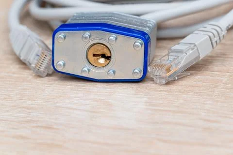 Bundle of network wires with metal padlock on the table Stock Photos