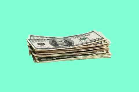 A bundle of one hundred dollar bills on a green background. Isolated Stock Photos
