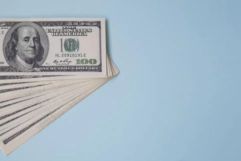Bundle of one hundred dollar bills on a blue background. 100 US Foto stock